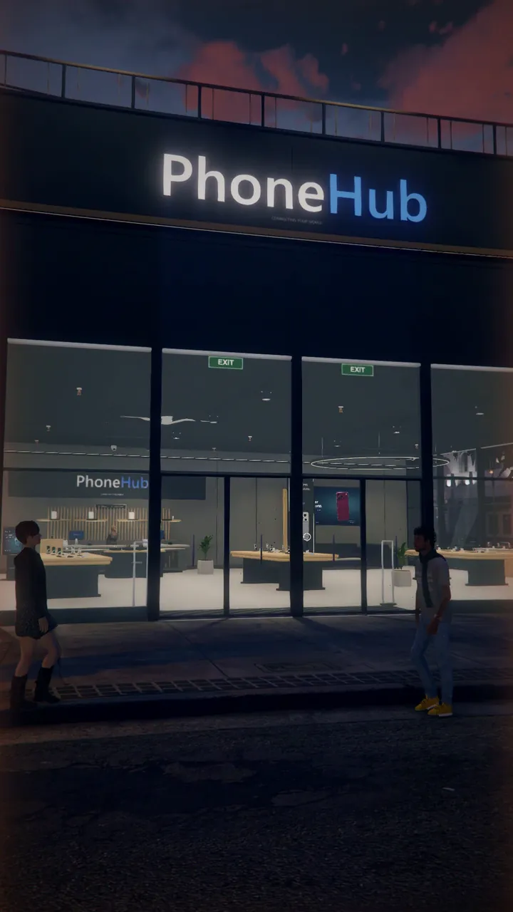 The PhoneHub store on Portola Drive at dusk, with its lit sign and customers walking past.